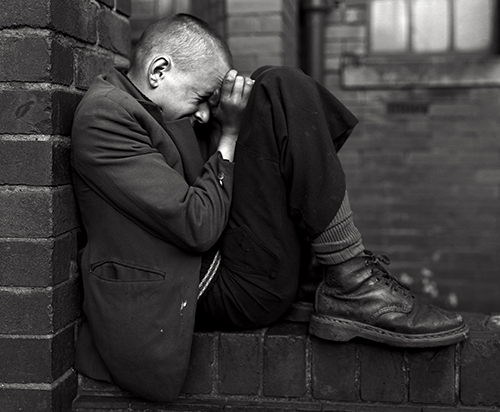 https://francefineart.com/ Chris Killip, Jeune sur un mur, Jarrow, Tyneside, 1976. © Chris Killip Photography Trust / Magnum Photos. Courtesy Wilson Centre for Photography.